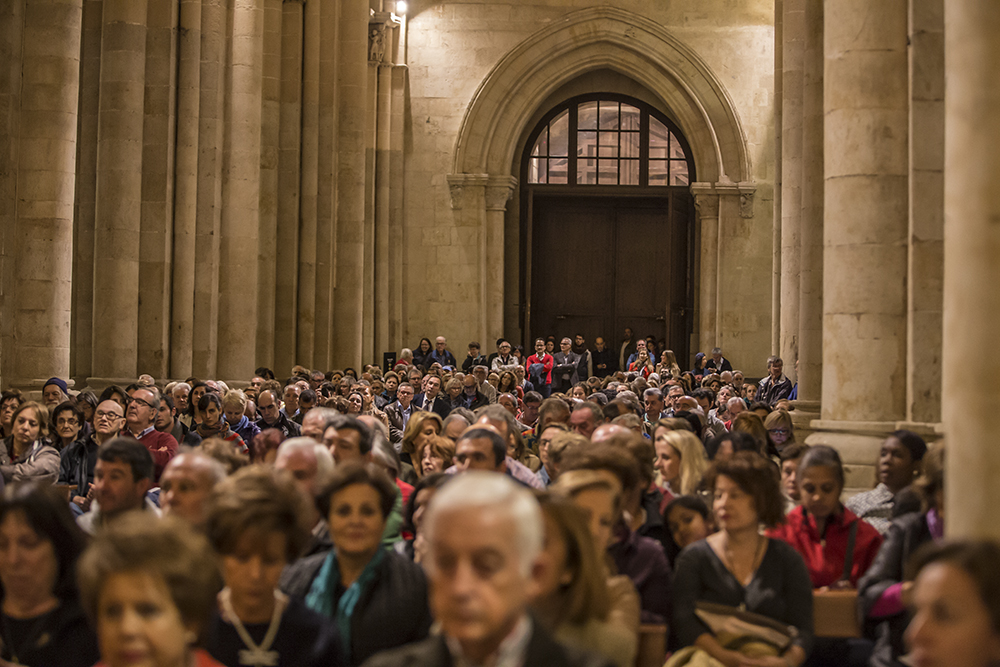 Perspective photo of audience, full and standing audience in cathedral